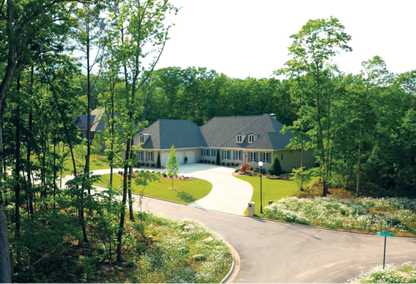 Winding driveway leading to a large lot and family home